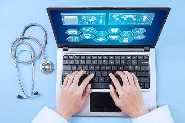 Close up of male doctor working on a laptop for analyzing human illness