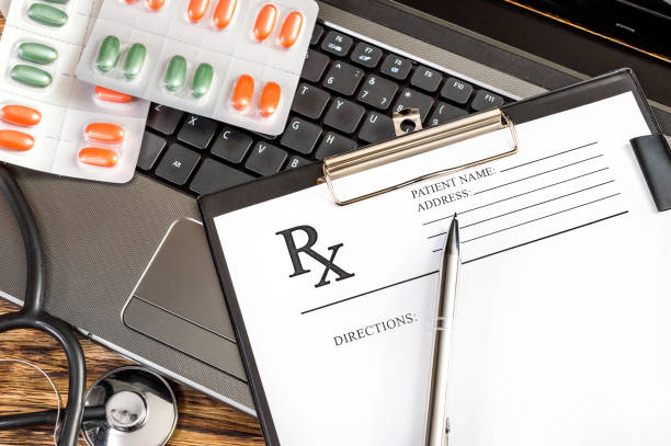 Prescription form with stethoscope and pills on the laptop keyboard. Prescription form with stethoscope and pills on the laptop keyboard.