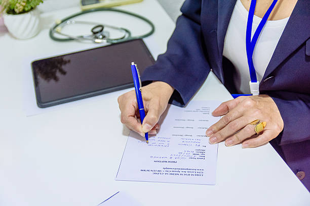 s2 Doctor's hands writing notes and medical prescriptions for patient, embodying the concepts of healthcare, treatment, medicine, and professional medical practice