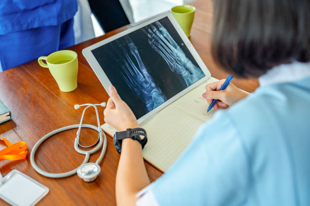 medical staff using digital tablet looking on x-ray at medical clinic medical staff using digital tablet looking on x-ray at medical clinic